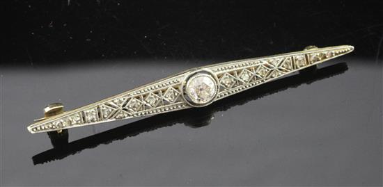 An Art Deco 18ct gold, platinum and diamond bar brooch, 2.25in.